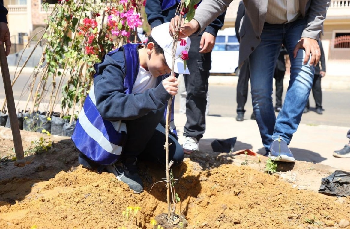 Student plants tree at El-Sherouk City campus